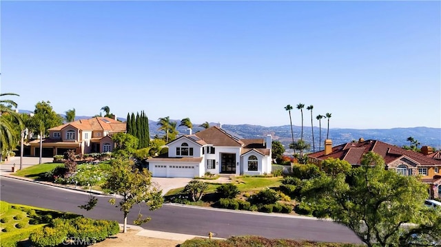 4855 Green Crest Dr, Yorba Linda, CA 92887 - view of front facade with concrete driveway and a mountain view