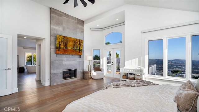 4855 Green Crest Dr, Yorba Linda, CA 92887 - bedroom with high vaulted ceiling, access to outside, a tiled fireplace, wood finished floors, and french doors