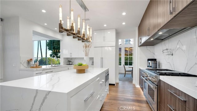 4855 Green Crest Dr, Yorba Linda, CA 92887 - kitchen featuring high end appliances, modern cabinets, recessed lighting, light wood-style floors, and decorative backsplash