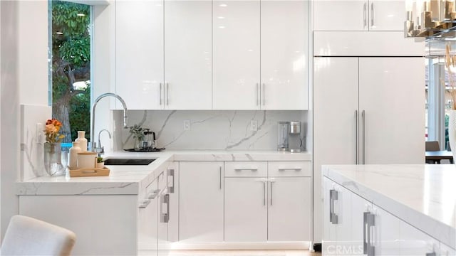 4855 Green Crest Dr, Yorba Linda, CA 92887 - kitchen with modern cabinets, white cabinetry, decorative backsplash, and light stone countertops