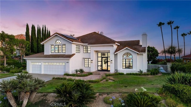 4855 Green Crest Dr, Yorba Linda, CA 92887 - view of front of property with an attached garage, roof mounted solar panels, a chimney, and driveway