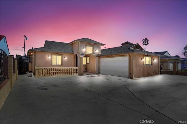 7060 Morse Ave, North Hollywood, CA 91605 - view of front facade with driveway, a garage, stucco siding, and a gate