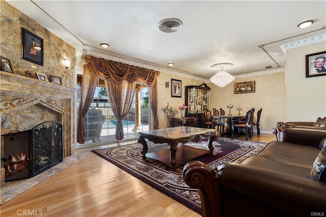 7060 Morse Ave, North Hollywood, CA 91605 - living room featuring wood-type flooring, a premium fireplace, and crown molding