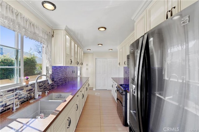 7060 Morse Ave, North Hollywood, CA 91605 - kitchen with stainless steel appliances, tasteful backsplash, glass insert cabinets, recessed lighting, and white cabinetry