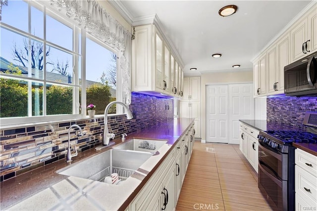 7060 Morse Ave, North Hollywood, CA 91605 - kitchen with stainless steel appliances, backsplash, dark countertops, white cabinetry, and glass insert cabinets