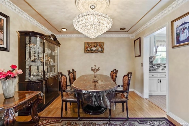 7060 Morse Ave, North Hollywood, CA 91605 - dining room featuring light wood-type flooring, a chandelier, and crown molding