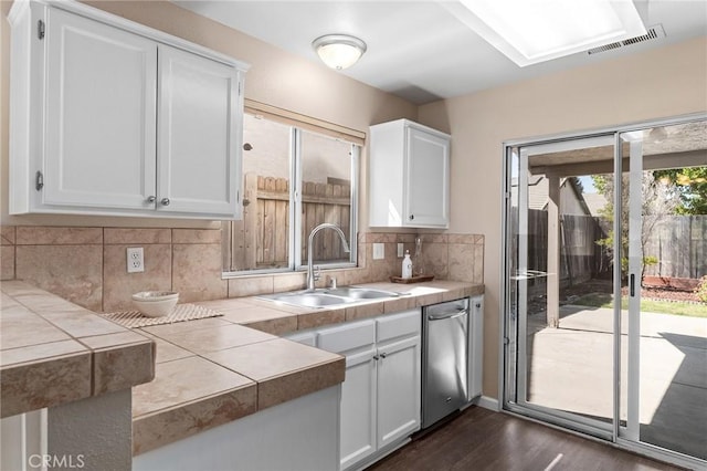 2078 Mansfield Ct, Chico, CA 95928 - kitchen featuring stainless steel dishwasher, tile counters, dark wood-style flooring, and white cabinets