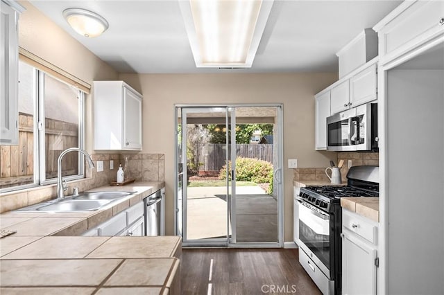 2078 Mansfield Ct, Chico, CA 95928 - kitchen with stainless steel appliances, dark wood-style flooring, and white cabinetry
