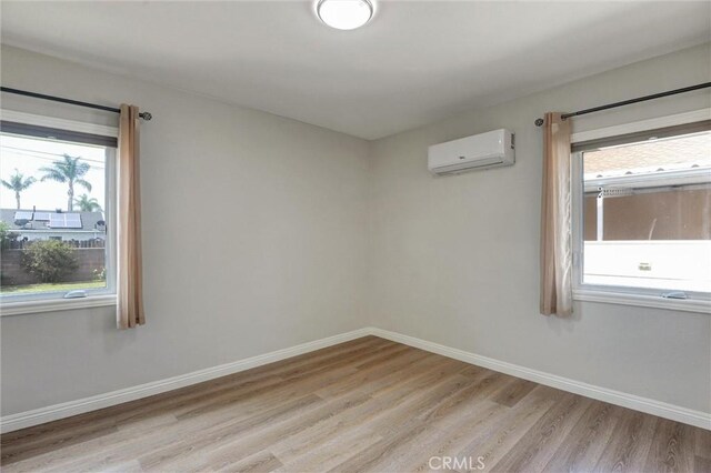 108 Chula St, Monrovia, CA 91016 - empty room featuring a wall mounted AC and light wood-style floors