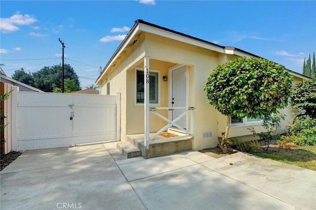 108 Chula St, Monrovia, CA 91016 - view of property exterior featuring stucco siding, a gate, and a patio area