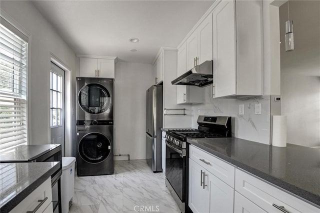 108 Chula St, Monrovia, CA 91016 - kitchen featuring stainless steel appliances, under cabinet range hood, stacked washing machine and dryer, light marble finish flooring, and white cabinetry