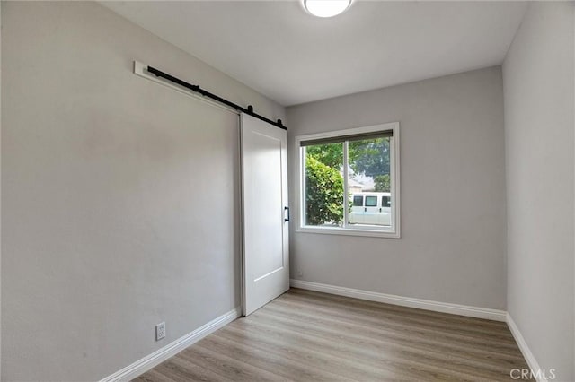 108 Chula St, Monrovia, CA 91016 - unfurnished room with a barn door and wood finished floors