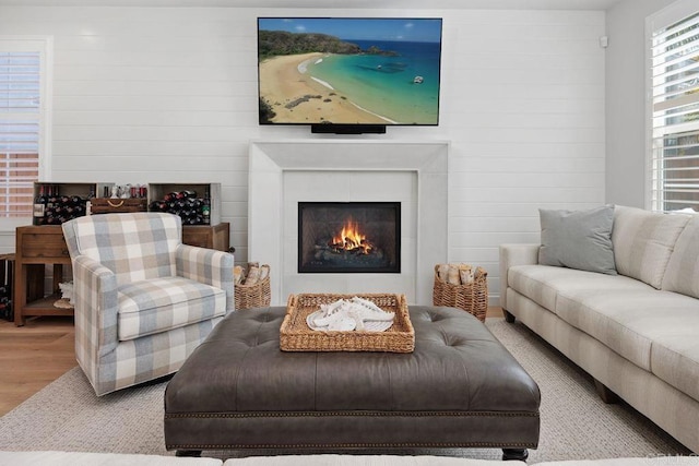 6925 Waters End Dr, Carlsbad, CA 92011 - living area with wood finished floors, a warm lit fireplace, and wood walls