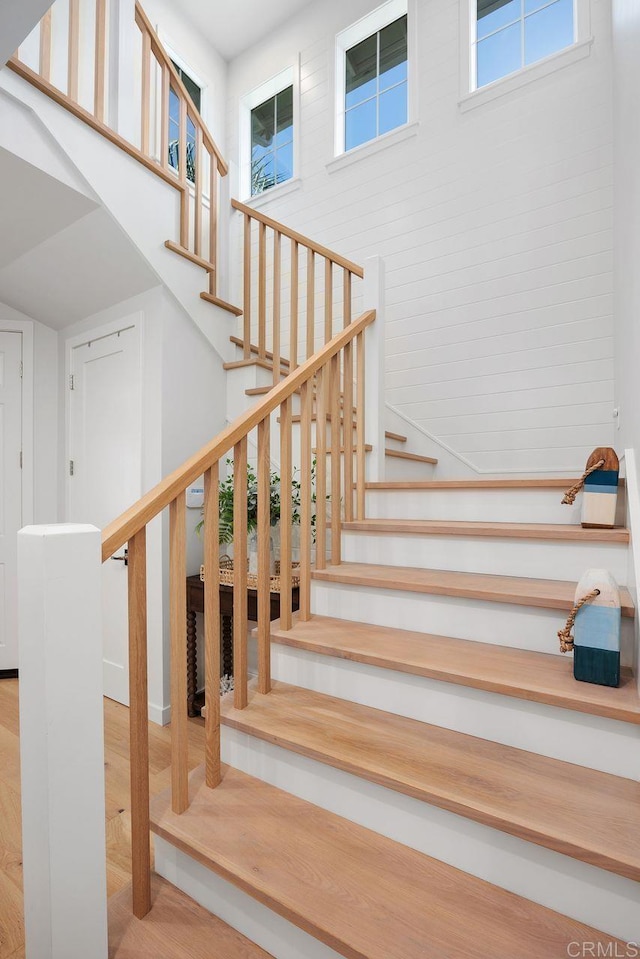 6925 Waters End Dr, Carlsbad, CA 92011 - stairs with a high ceiling and wood finished floors