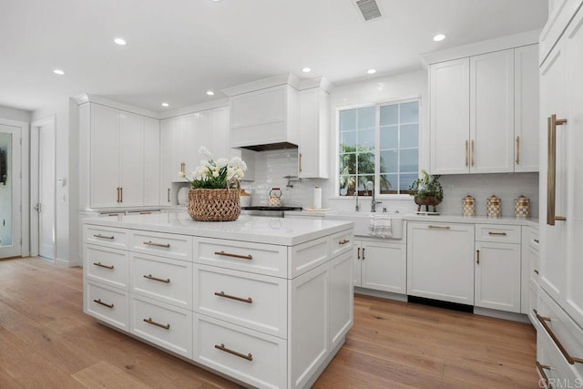 6925 Waters End Dr, Carlsbad, CA 92011 - kitchen with backsplash, white cabinetry, and recessed lighting