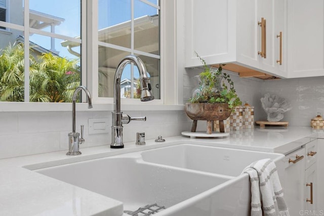 6925 Waters End Dr, Carlsbad, CA 92011 - kitchen view of white cabinetry, tasteful backsplash, and light countertops
