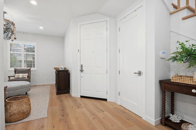 6925 Waters End Dr, Carlsbad, CA 92011 - entryway with light wood-style flooring, recessed lighting, lofted ceiling, and stairs