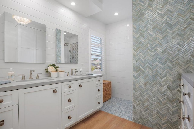 6925 Waters End Dr, Carlsbad, CA 92011 - bathroom featuring double vanity, a walk in shower, and wood finished floors
