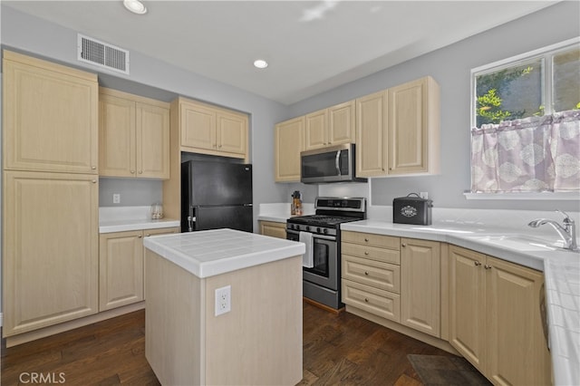 27151 Manor Cir Unit 54, Valencia, CA 91354 - kitchen featuring stainless steel appliances, light brown cabinets, tile counters, a kitchen island, and dark wood-style flooring