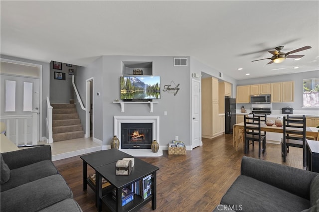 27151 Manor Cir Unit 54, Valencia, CA 91354 - living area featuring a ceiling fan, stairs, a warm lit fireplace, dark wood-type flooring, and recessed lighting