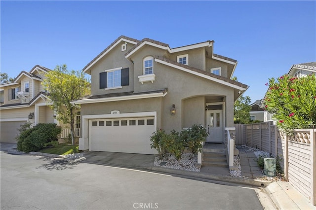 27151 Manor Cir Unit 54, Valencia, CA 91354 - traditional home with stucco siding, an attached garage, and driveway