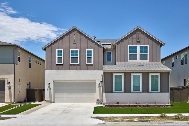 2415 Calle Grandon, Chula Vista, CA 91913 - view of front of home with roof mounted solar panels, an attached garage, board and batten siding, driveway, and a front yard