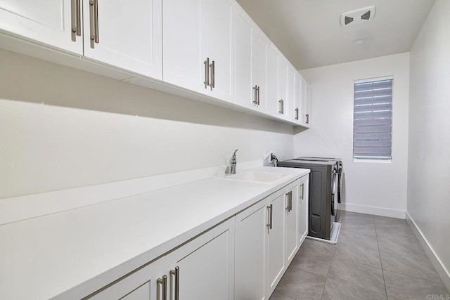 2415 Calle Grandon, Chula Vista, CA 91913 - laundry area with separate washer and dryer, cabinet space, and light tile patterned floors
