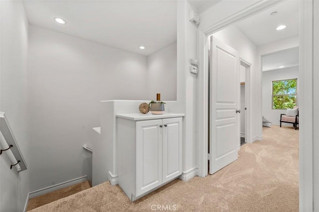 180 Guinevere, Irvine, CA 92620 - corridor featuring light carpet, recessed lighting, and an upstairs landing