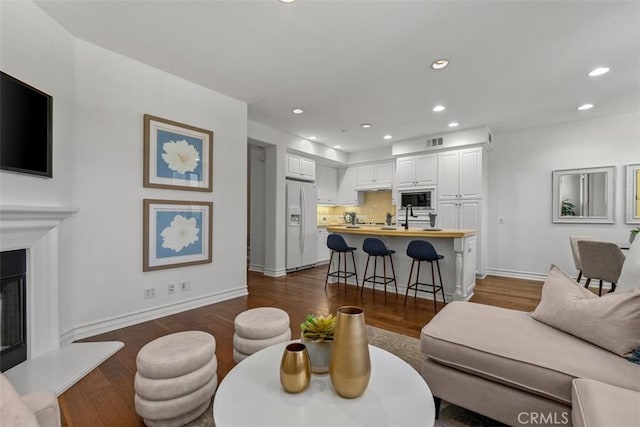 180 Guinevere, Irvine, CA 92620 - living area featuring recessed lighting, dark wood finished floors, and a glass covered fireplace