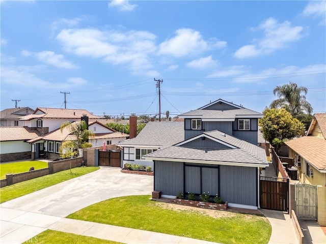 14750 Danbrook Dr, Whittier, CA 90604 - traditional-style home featuring a gate, roof with shingles, concrete driveway, and a residential view