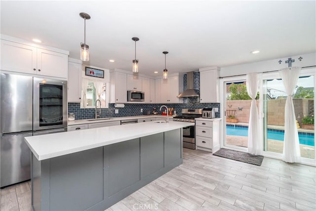 14750 Danbrook Dr, Whittier, CA 90604 - kitchen with appliances with stainless steel finishes, wall chimney exhaust hood, light countertops, decorative backsplash, and recessed lighting