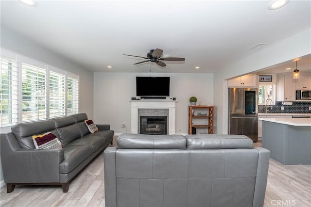 14750 Danbrook Dr, Whittier, CA 90604 - living room featuring light wood finished floors, a ceiling fan, recessed lighting, and a glass covered fireplace