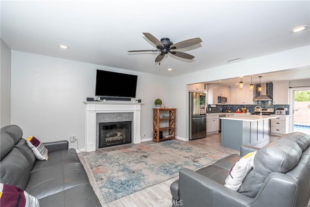 14750 Danbrook Dr, Whittier, CA 90604 - living room featuring a ceiling fan, light wood-style floors, a glass covered fireplace, and recessed lighting