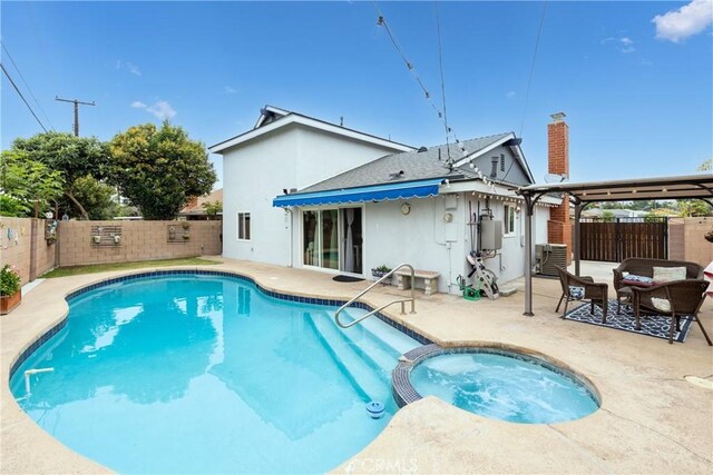 14750 Danbrook Dr, Whittier, CA 90604 - rear view of house with stucco siding, a patio, a fenced backyard, a pool with connected hot tub, and a chimney