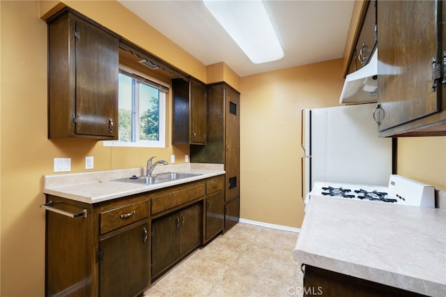 782 Lewis St, Pomona, CA 91767 - kitchen with white appliances, dark brown cabinetry, and light countertops