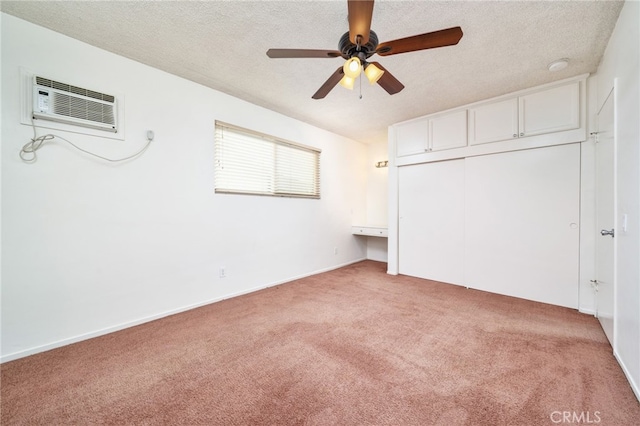 782 Lewis St, Pomona, CA 91767 - unfurnished bedroom featuring light colored carpet, an AC wall unit, a textured ceiling, a closet, and a ceiling fan