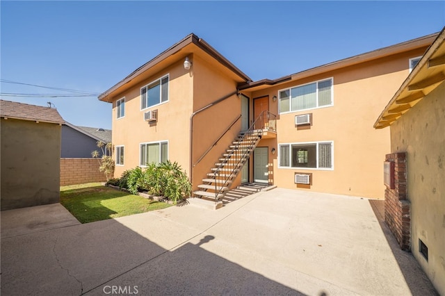 782 Lewis St, Pomona, CA 91767 - rear view of property featuring stucco siding, a patio, stairway, and cooling unit