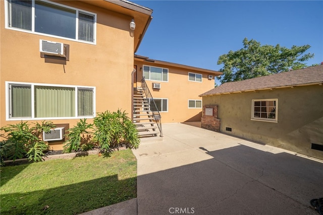 782 Lewis St, Pomona, CA 91767 - rear view of house featuring stairway, a patio, a yard, an AC wall unit, and stucco siding