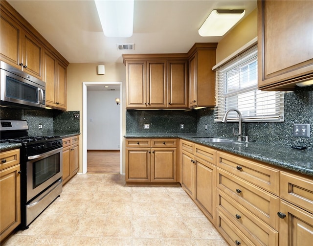 782 Lewis St, Pomona, CA 91767 - kitchen with appliances with stainless steel finishes, tasteful backsplash, dark stone countertops, and brown cabinets