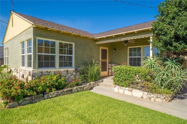 782 Lewis St, Pomona, CA 91767 - view of front of home featuring a front yard, stone siding, stucco siding, and ceiling fan