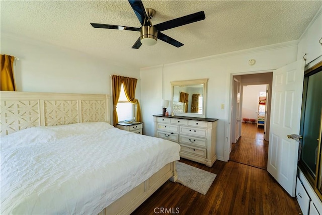 658 W 120th St, Los Angeles, CA 90044 - bedroom featuring dark wood-style flooring, a textured ceiling, and ceiling fan