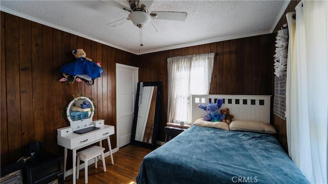 658 W 120th St, Los Angeles, CA 90044 - bedroom featuring a textured ceiling, wood walls, crown molding, dark wood-style flooring, and a ceiling fan