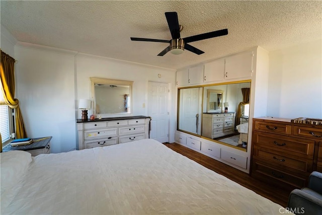 658 W 120th St, Los Angeles, CA 90044 - bedroom with dark wood-style flooring, a textured ceiling, crown molding, ceiling fan, and a closet