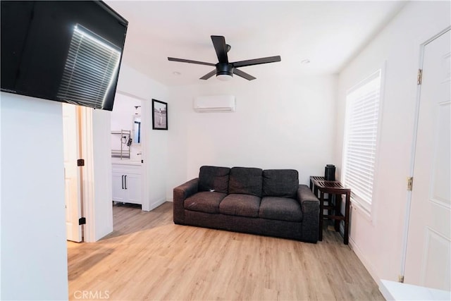 658 W 120th St, Los Angeles, CA 90044 - living area with light wood-type flooring, a wall unit AC, a ceiling fan, and plenty of natural light