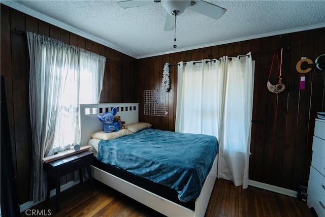 658 W 120th St, Los Angeles, CA 90044 - bedroom with a textured ceiling, wooden walls, wood finished floors, crown molding, and ceiling fan