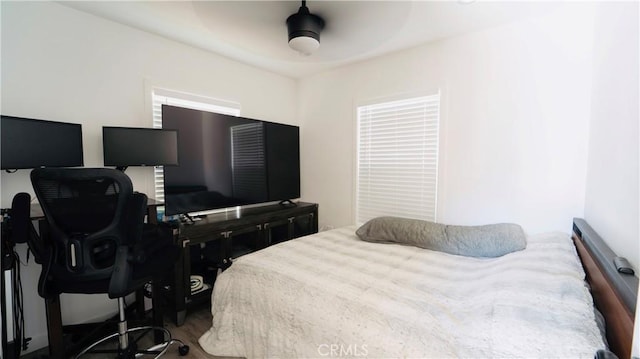 658 W 120th St, Los Angeles, CA 90044 - bedroom with wood finished floors, a desk, and a ceiling fan