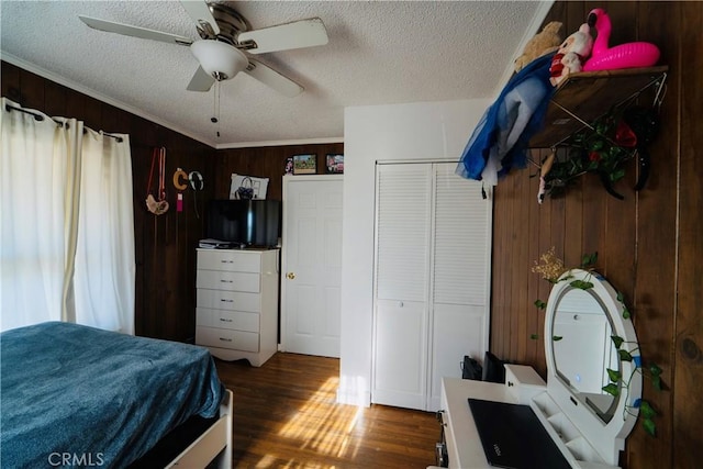 658 W 120th St, Los Angeles, CA 90044 - bedroom with wood finished floors, wooden walls, a textured ceiling, crown molding, and ceiling fan