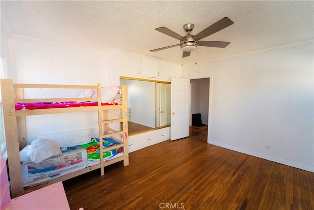 658 W 120th St, Los Angeles, CA 90044 - bedroom with wood-type flooring, ornamental molding, a textured ceiling, a closet, and a ceiling fan