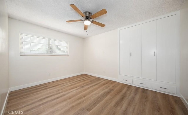 25070 Tulip Ave, Loma Linda, CA 92354 - unfurnished bedroom with a textured ceiling, wood finished floors, a closet, and a ceiling fan