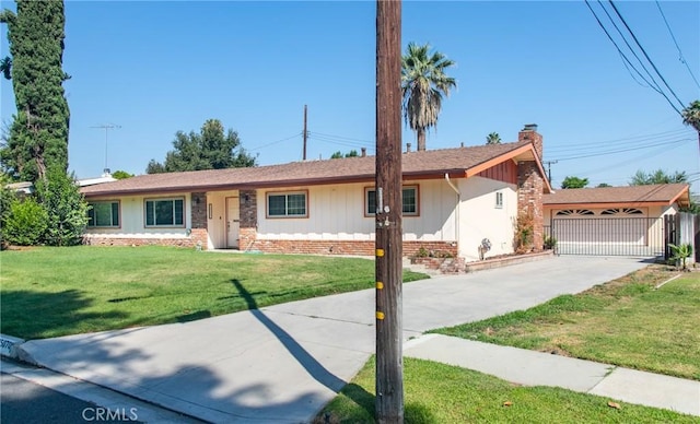 25070 Tulip Ave, Loma Linda, CA 92354 - ranch-style house featuring a chimney, a front lawn, brick siding, board and batten siding, and a garage